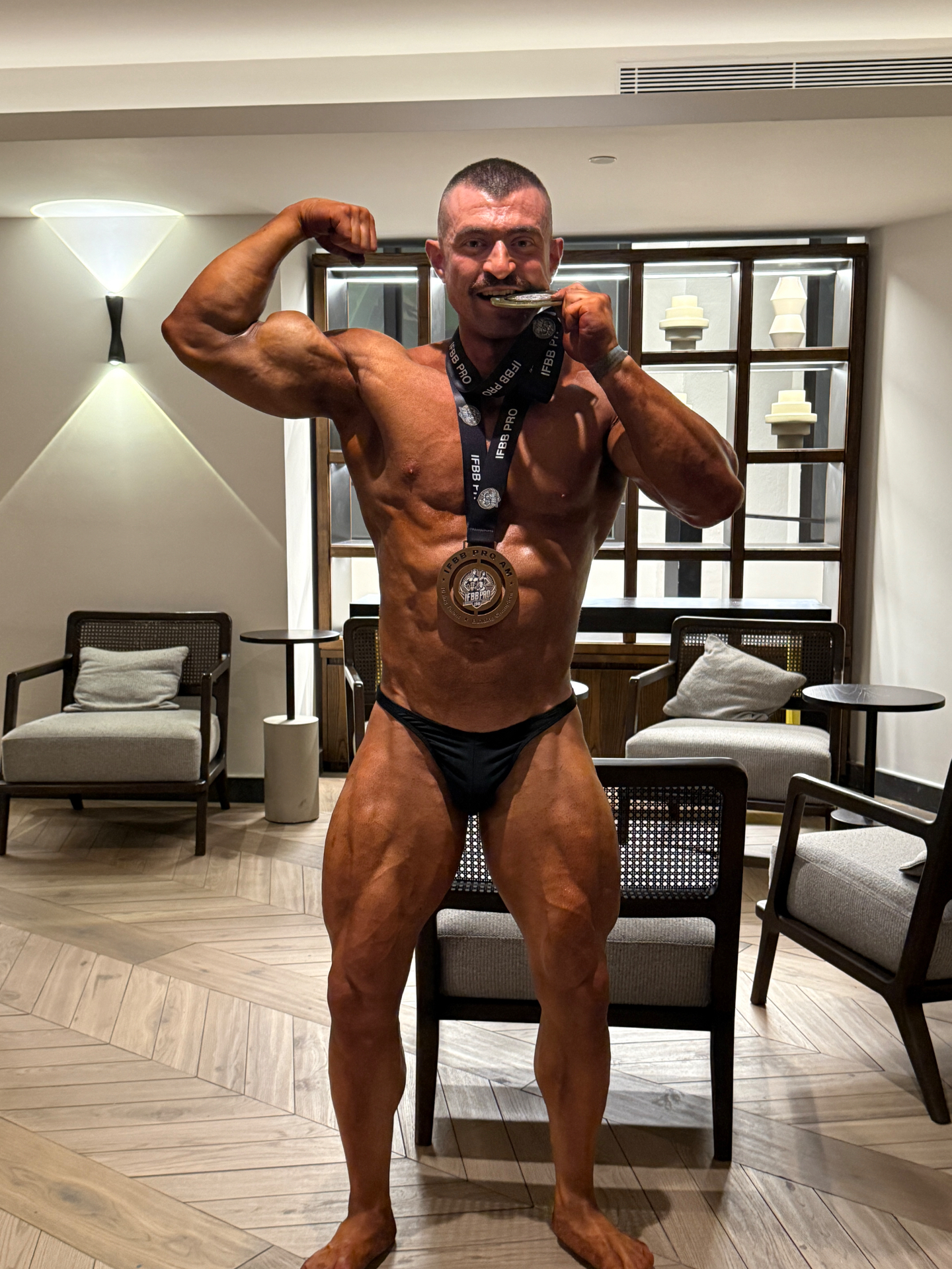 Joseph Scerri celebrating his IFBB medal win — a proud moment of dedication rewarded